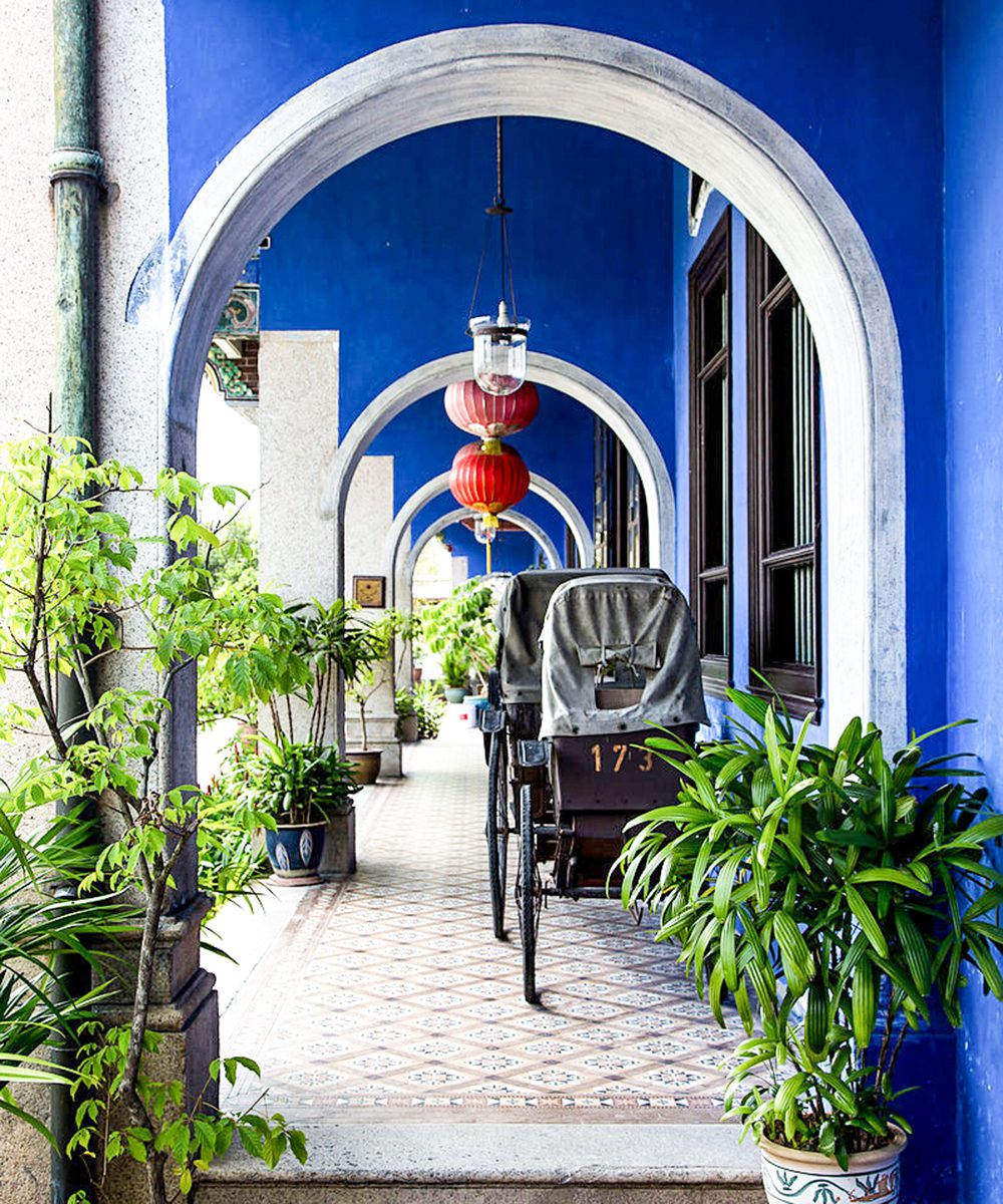 Cheong Fatt Tze Mansion - Bright red oriental lanterns shine bright against the blue colour