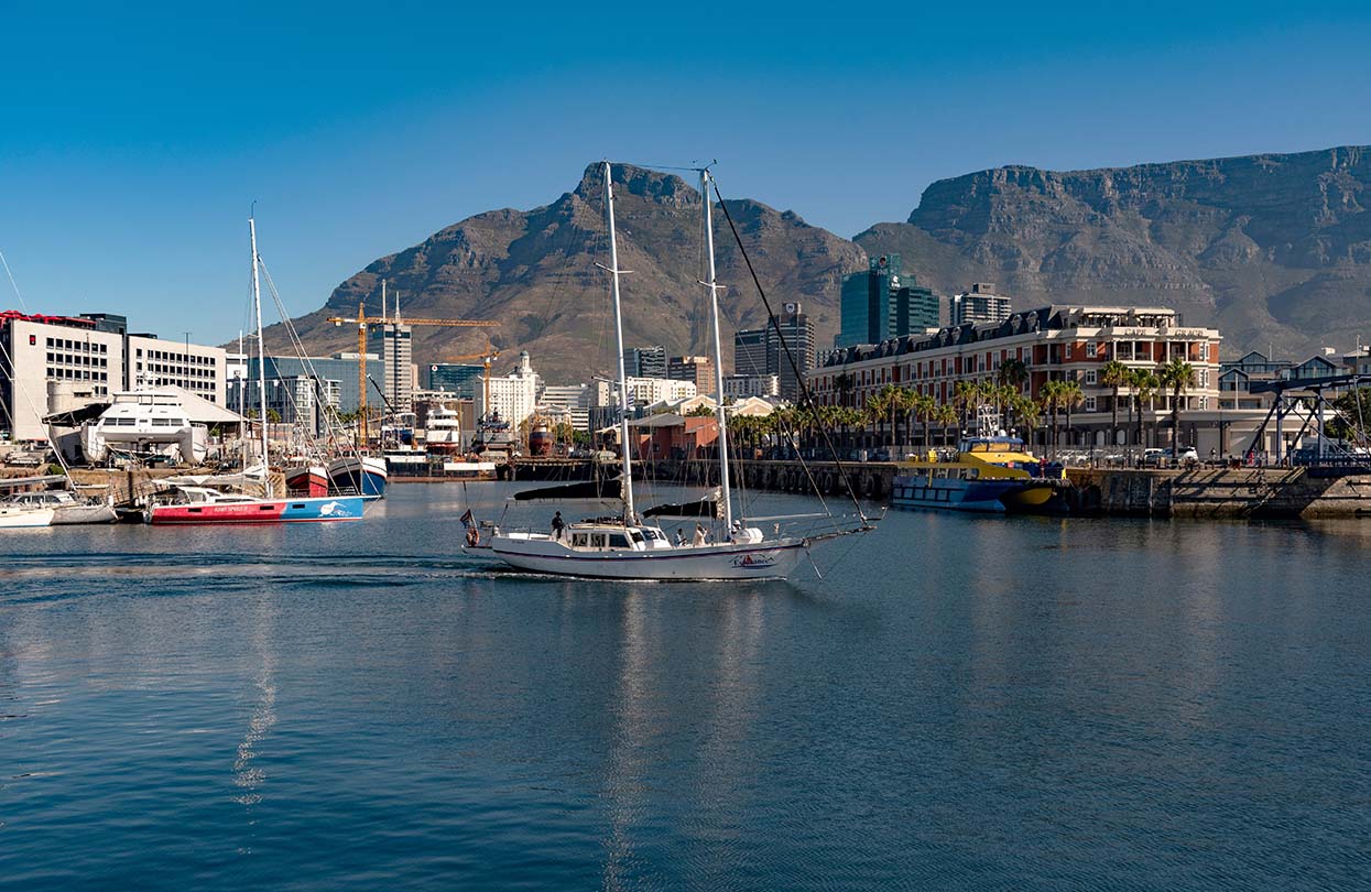 Tourist trip yacht crossing Cape Town Harbour, image by Peter Titmuss shutterstock